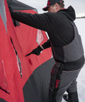 A person sets up the Heavy Duty Pop Up Insulated Ice Fishing Shelter With Knockout Spacious Fishin Spot For Five To Seven Crews.