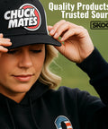 Person wearing a Chuck Mates cap, adjusting the brim, with quality products text in the background.