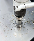 IDEAL carbide hole cutter on metal surface with shavings; silver tool with knurled black grip
