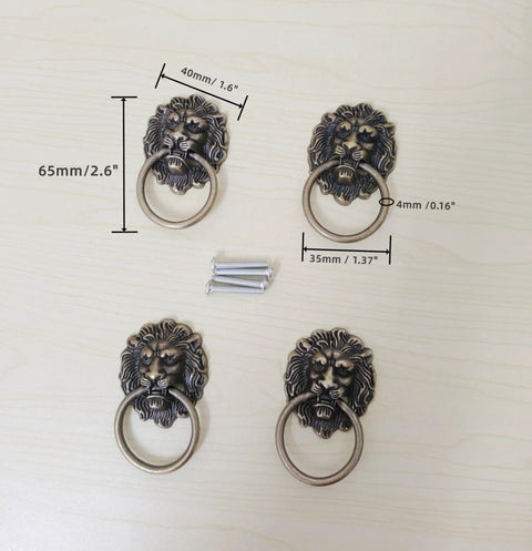 Antique Bronze Lion Head Ring Pull Cabinet Handles Set Of 4 With Screws, 2.6 Inches Long By 1.6 Inches Wide, displayed on table