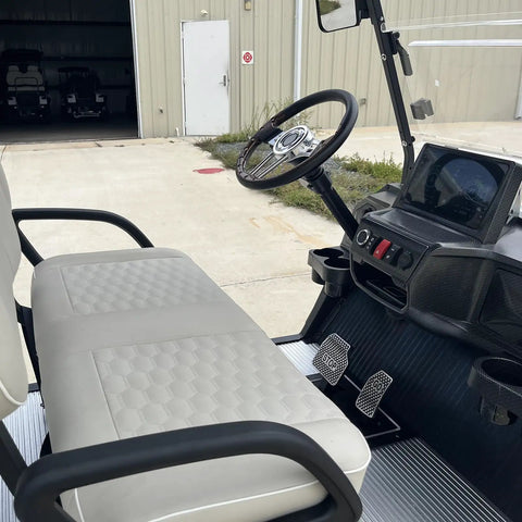 High Capacity Six Passenger Electric Golf Cart Featuring Rear Flip Seats Quiet Motor Drive plush padded upholstery and built in armrests, driver's seat with dashboard.