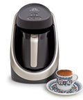 Electric Turkish Coffee Pot With Cook Sense Technology 1 To 4 Cup Capacity BPA Free 120V Delivers Bold Turkish And Greek Coffee Easy Brew For Home Use Durable Turkish Coffee Maker Built For True Coffee Lovers with a decorative coffee cup.
