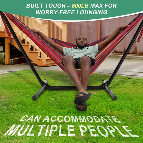 Person relaxing in the 3 In 1 Portable Outdoor Hammock With Stand And Carry Bag, heavy-duty steel frame, 600 lb weight capacity, in a backyard.