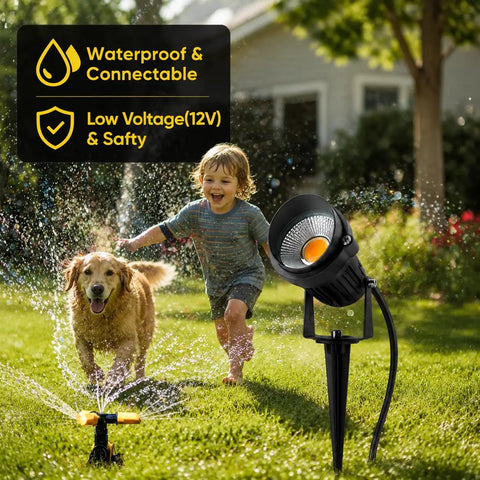 Child and dog playing near 8 Pack 5W Low Voltage LED Landscape Lights With Spike Stands And Quick Connectors, outdoor scene.