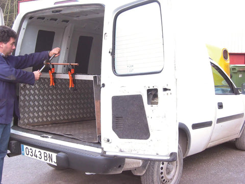 Man in van using 4-Piece Hands-Free Pliers And Grip Holder Set With Locking Pliers And Durable Vinyl Roll-Up Pouch