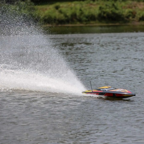Sonicwake V2 36 Inch Self Righting Brushless RC Boat speeding on water, deep-V hull creating splash, black color.