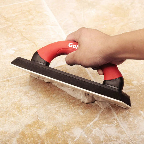 User using 4 Inch By 12 Inch Grout Float For Tile With Molded Rubber Pad and Soft Grip Handle on tile floor