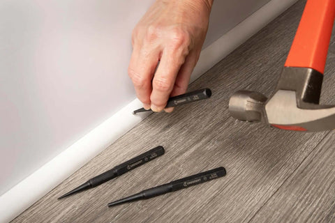 Using Pro Grade 3 Piece 5 Inch Steel Punch Set with black oxide finish, laser etched size markings, knurled handles for firm grip on wood floor