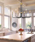 Six Light Black And Gold Farmhouse Chandelier For Dining Room And Kitchen Island above marble island in bright kitchen.
