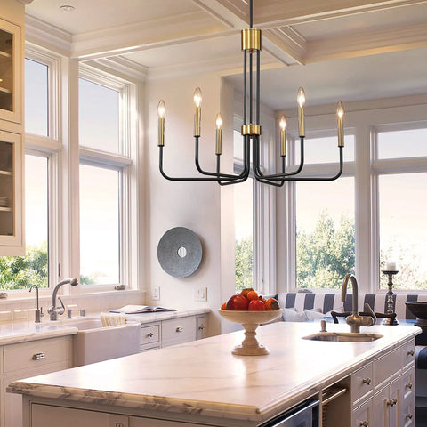 Six Light Black And Gold Farmhouse Chandelier For Dining Room And Kitchen Island above marble island in bright kitchen.