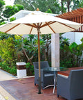 Heavy Duty Patio Umbrella Base With Adjustable Clamp For Decks Patios Balconies And Docks Outdoor Umbrella Stand Fits Post 0.8 To 1.5 Inches Secure Setup Easy To Use Weatherproof And Wind Resistant Built To Hold Up under a garden table on a wooden patio with chairs.
