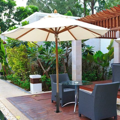 Heavy Duty Patio Umbrella Base With Adjustable Clamp For Decks Patios Balconies And Docks Outdoor Umbrella Stand Fits Post 0.8 To 1.5 Inches Secure Setup Easy To Use Weatherproof And Wind Resistant Built To Hold Up under a garden table on a wooden patio with chairs.
