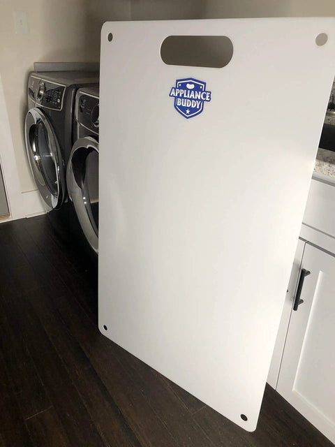 Image of a Heavy Duty Appliance Slider Mat with a large handle, positioned upright next to laundry machines on a hardwood floor.