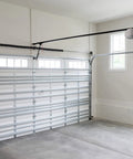 Steel garage door with 0.207 inch torsion spring upgrade, visible right-hand wind mechanism and 22 inch length, in a clean garage.
