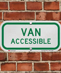 Heavy Duty Six By Twelve Inch Van Accessible Metal Sign Built Tough With Sixty Three Mil Aluminum And Legit 3M Engineer Grade Reflective Coating In Clean Green On White, mounted on a brick wall.