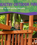 Child playing on wooden playset featuring a Captain Ship Wheel Swing Set Accessory with 20-inch 360-degree rotating wheel.