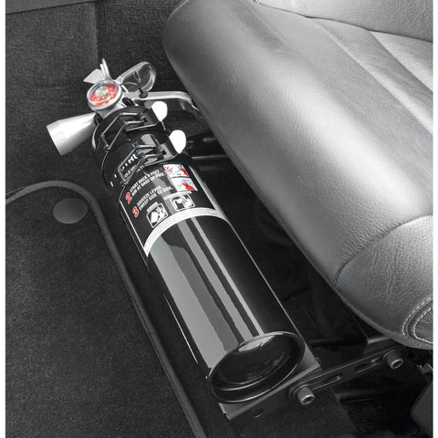 Compact Halon 1211 Auto Fire Extinguisher in black, positioned under a car seat for easy access, designed for daily drivers.