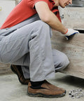 Heavy Duty Metal Shelf Clips With Super Sturdy Adjustable Mounts For Closets And Bookshelves being installed by a man crouching.