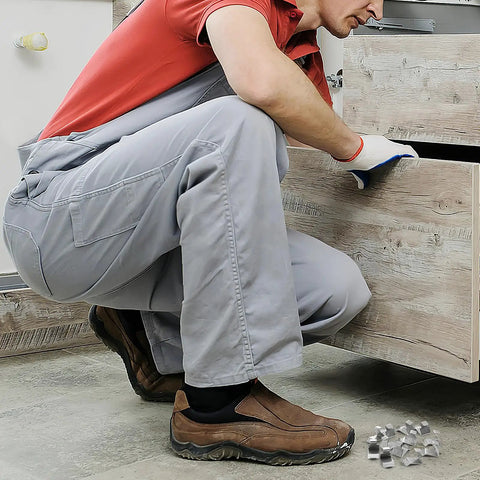 Heavy Duty Metal Shelf Clips With Super Sturdy Adjustable Mounts For Closets And Bookshelves being installed by a man crouching.