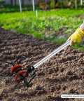 Person using Six Claw Deep Plow Cultivator Wheel Attachment For Weed Busting On Lawn Mowers And Rototillers Steel Soil Aerator Weeder Tool