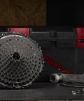 TRS Plus 11-Speed Mountain Bike Cassette 9-46T Black displayed on a workbench, showing its durable and lightweight design.