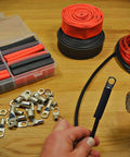 Pro Grade 130 Piece Dual Wall Adhesive Marine Heat Shrink Kit With Multi Color Tubing And Three To One Shrink Ratio shown with tools