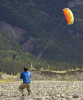 Person flying Dual Line Parafoil Kite For Easy Kiting, Synapse 140 Cilantro Color in mountain scenery, no frame parts to lose