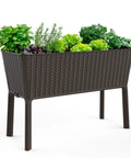 Side view of the Splendor 31.7 Gallon Raised Garden Bed with self watering planter box and drainage plug in brown with green plants.