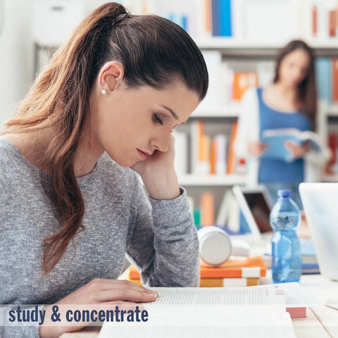 Focused woman studying with diverse students and books in library background
