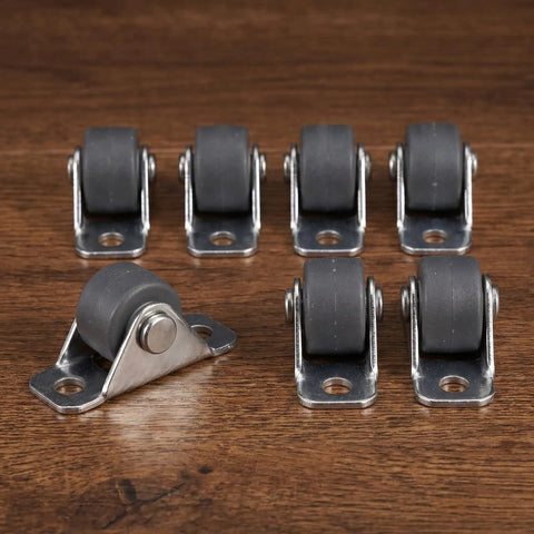 Eight Piece Low Profile Rigid Rubber Caster Wheels Non Swivel Fixed Plate Casters with grey wheels on a wooden surface.