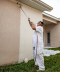 Pro Grade Spray And Roll Painting Kit With Three Foot Pole For Textured Walls in use on exterior wall for smooth finish.