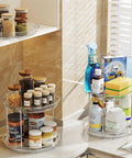 Smooth Spinning Two Tier Lazy Susan Turntable Organizer For Kitchen Pantry Fridge And Bathroom Vanity Spice Rack Storage Total No Fuss Slick Compact 9.25 Inch Dual Pack System with jars and cleaning supplies in use