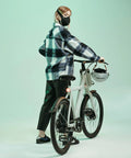 Person wearing Road Ready Nano Light Hexagon Motorcycle Half Face Mask With Anti Pollution Filter, standing beside a bicycle indoors.