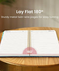 Open Spiral Notebook With Five Removable Dividers And Tabs, 8.5x11 Hardcover 280-Page Five Subject Journal For Women on table