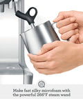 Barista Grade Espresso Machine With Integrated Conical Burr Grinder Bean To Cup Coffee Maker Featuring Manual Steam Wand For Creamy Microfoam, user steaming milk with steam wand.