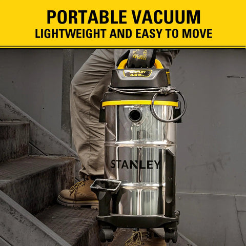 Person using Beast Mode Suction 4 Peak HP Shop Vacuum Wet Dry 5 Gallon With Stainless Steel Drum on stairs, portable view.