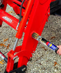 Person installing Space Saving Hidden Torque Tube Tool Tray Organizer for Front End Loader Tractor onto loader tubes.