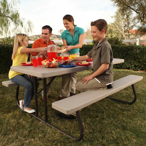 Family enjoying outside meal at 6-Foot Folding Picnic Table for Backyard Use With Eight-Seat Capacity, UV Protected HDPE Top, Powder Coated Steel Frame