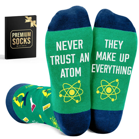 Funny Nerdy Socks For Men And Women Science Teacher Stocking Stuffers Pharmacist Gift Chemistry Physics Neuroscience Humor Geeky Christmas Socks Gift For Scientists And Medical Pros with atom design and text "Never Trust an Atom They Make Up Everything" on green socks.