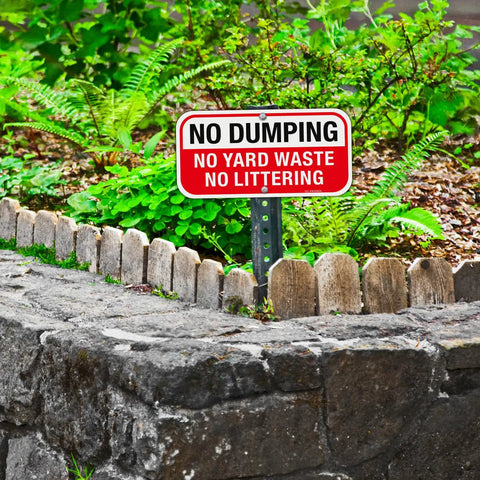 Heavy Duty No Dumping And No Littering Sign 2 Pack Rust Proof Aluminum Property Boundary Signs 12x6 Inches Clear warning sign in yard.
