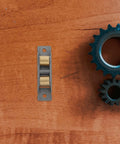 Close-up of Heavy Duty Stainless Steel Sliding Door Rollers And Patio Track Wheels For Horizontal Glass Panels on a wooden surface.