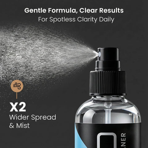 Front view of eyeglass cleaner spray bottle releasing mist; clear bottle, black label with blue accent