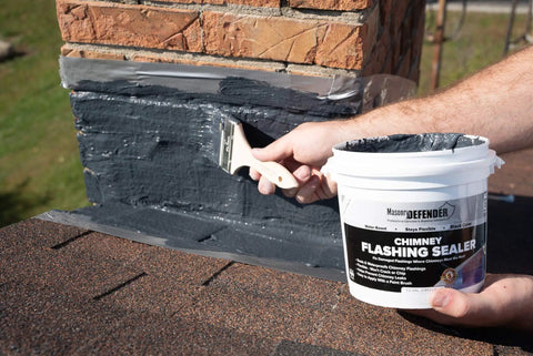 Applying Chimney Flashing Sealer And Roof Sealant That Keeps Water Out on brick chimney, 2.2 kg container visible