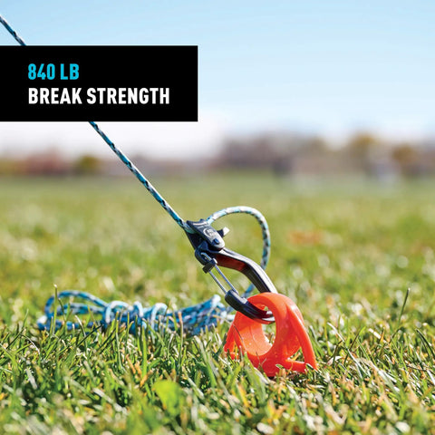 CamJam SlideLock Bungee Cord Tightener with pull to tighten lock and quick release lever securing cord in grass, 840 lb break strength.