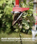 Claw Pro Garden Tiller And Cultivator Tool With Twist Action Soil Loosener removing a weed with adjustable carbon steel tines