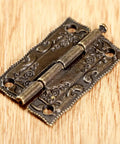 2 Pack Cabinet Door Hinges 36x23mm Wooden Box Decorative Hinges with intricate design on wood surface