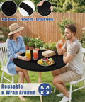 Round Spandex Tablecloth With Elastic Edge No Slip Waterproof Stretch Fit For 45 To 56 Inch Tables Ideal For Indoor Outdoor Dining And Camping Picnics Easy Care Washable Black covering table with people dining outdoors.