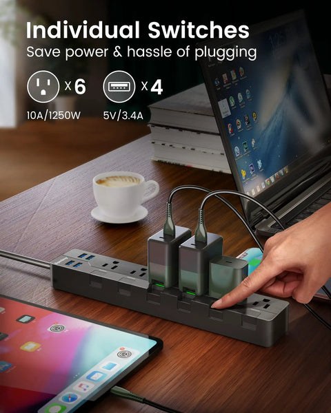 Power Strip With Individual Switches 6 Outlets And 4 USB Ports 900J Surge Protector on desk with electronic devices.