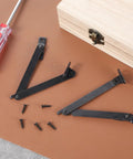 Two Pack Lid Support Hinges, Rotatable Folding Black Cabinet Hinges With Soft Close Locking on brown surface with screws