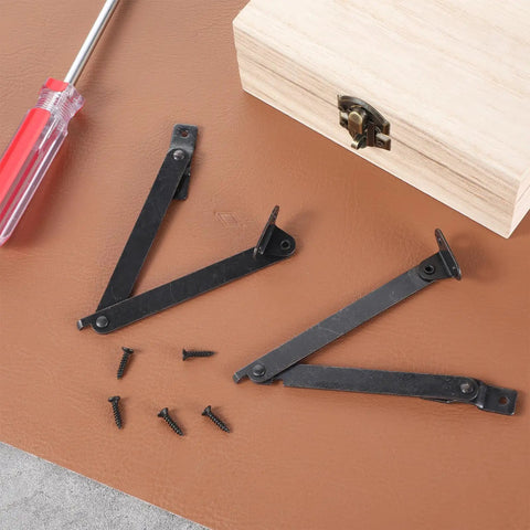 Two Pack Lid Support Hinges, Rotatable Folding Black Cabinet Hinges With Soft Close Locking on brown surface with screws